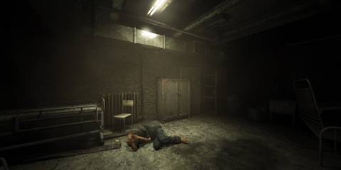 a man crouched on the floor in a dark room