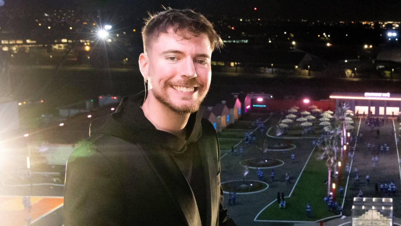 mrbeast smiling with beast games city behind him