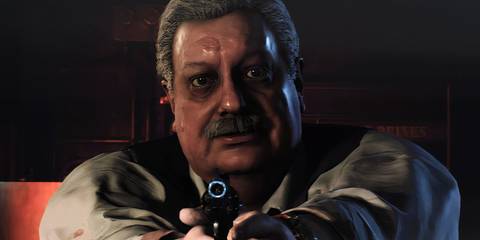 Chief Irons aiming a handgun at the screen 