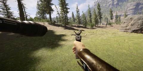 The player using a Revolver against a Cannibal in an open field
