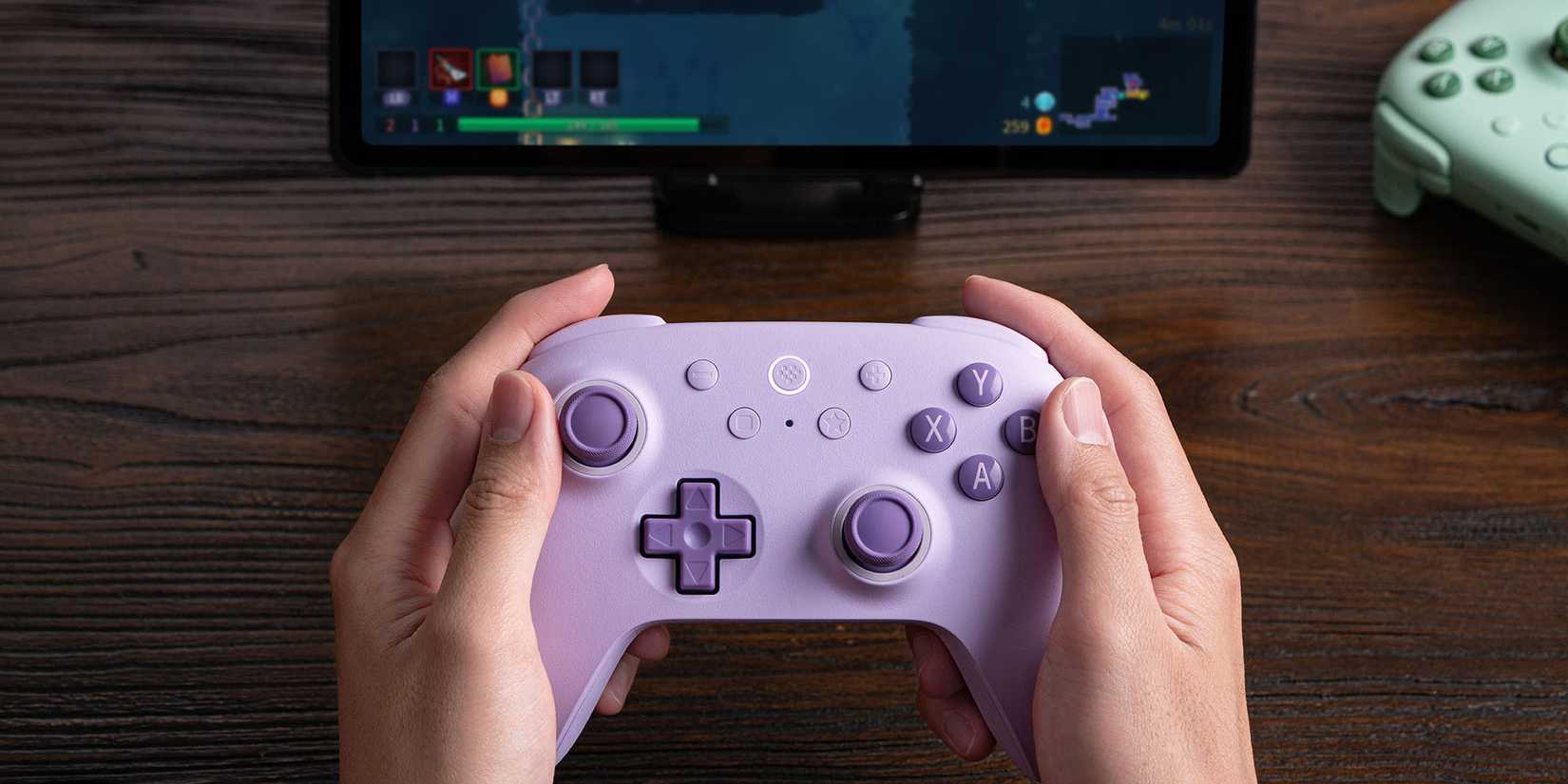 Someone gaming with the 8BitDo Ultimate 2C controller.