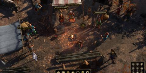 A lively Viking camp with NPCs around a bonfire in Expeditions Viking, an underrated isometric RPG