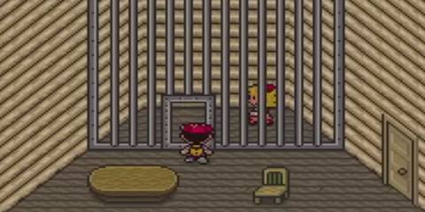 ness talking to paula behind a jail