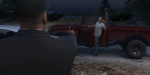 franklin points a gun at trevor in grand theft auto 5