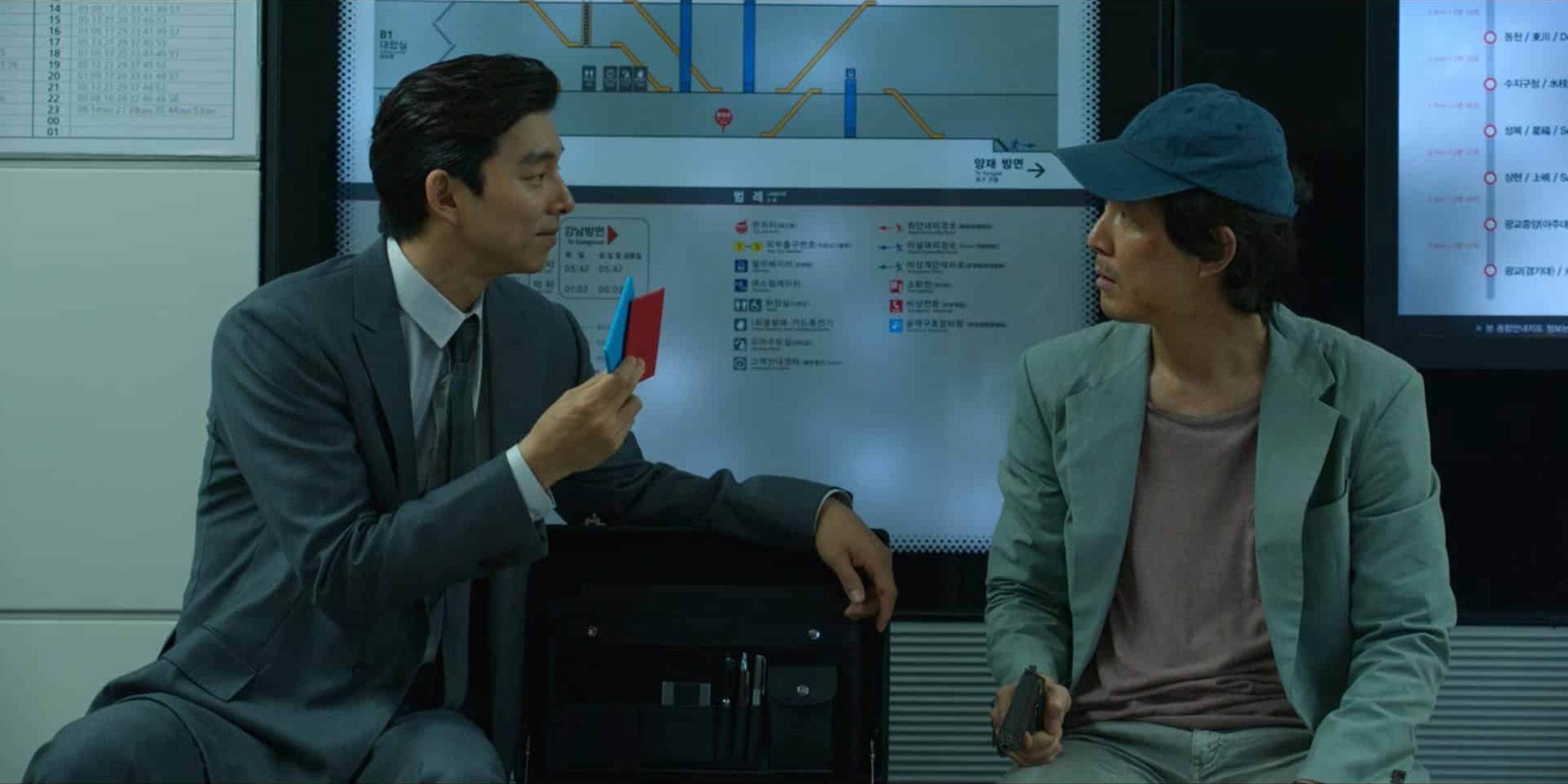 The Recruiter playing ddakji with Seong Gi-hun in Squid Game