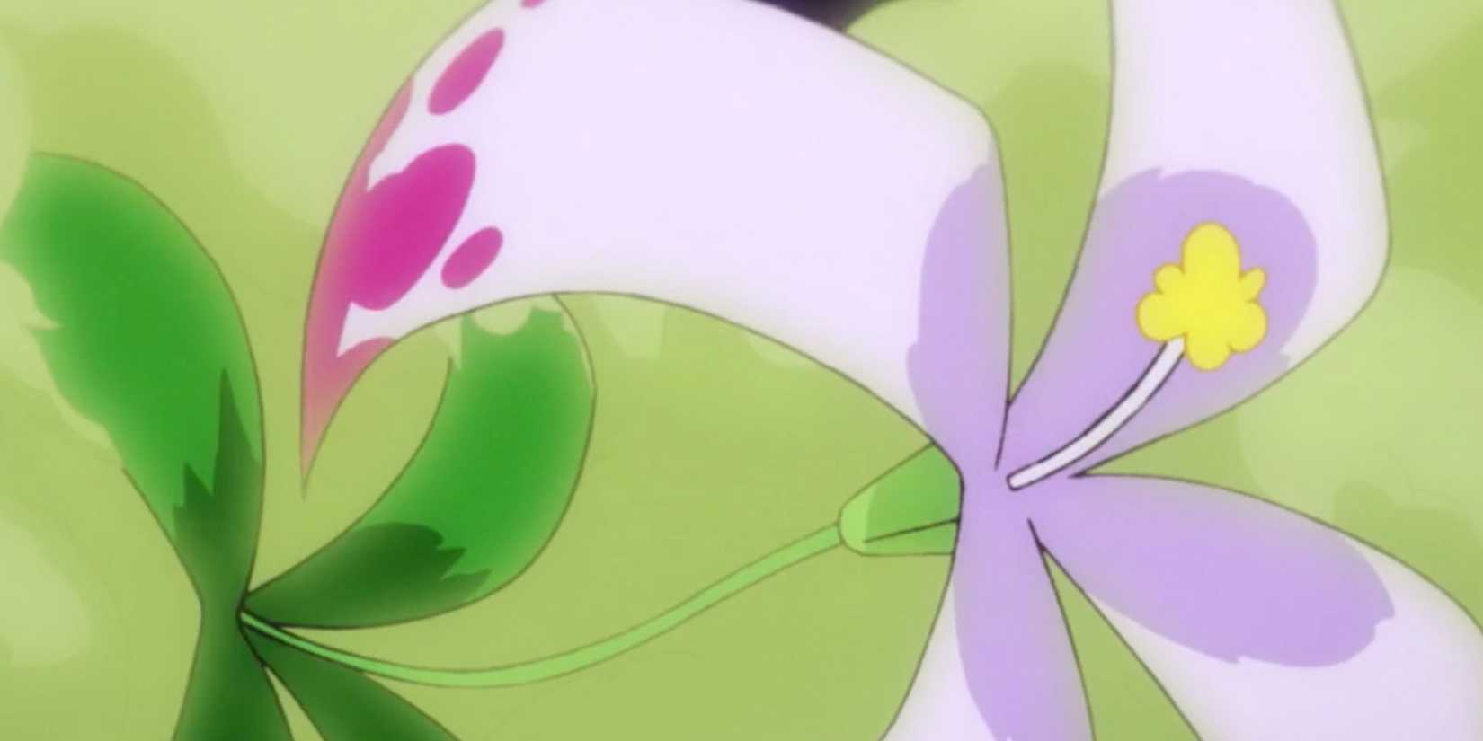 A pale purple flower with dark purple spots coated in a green haze