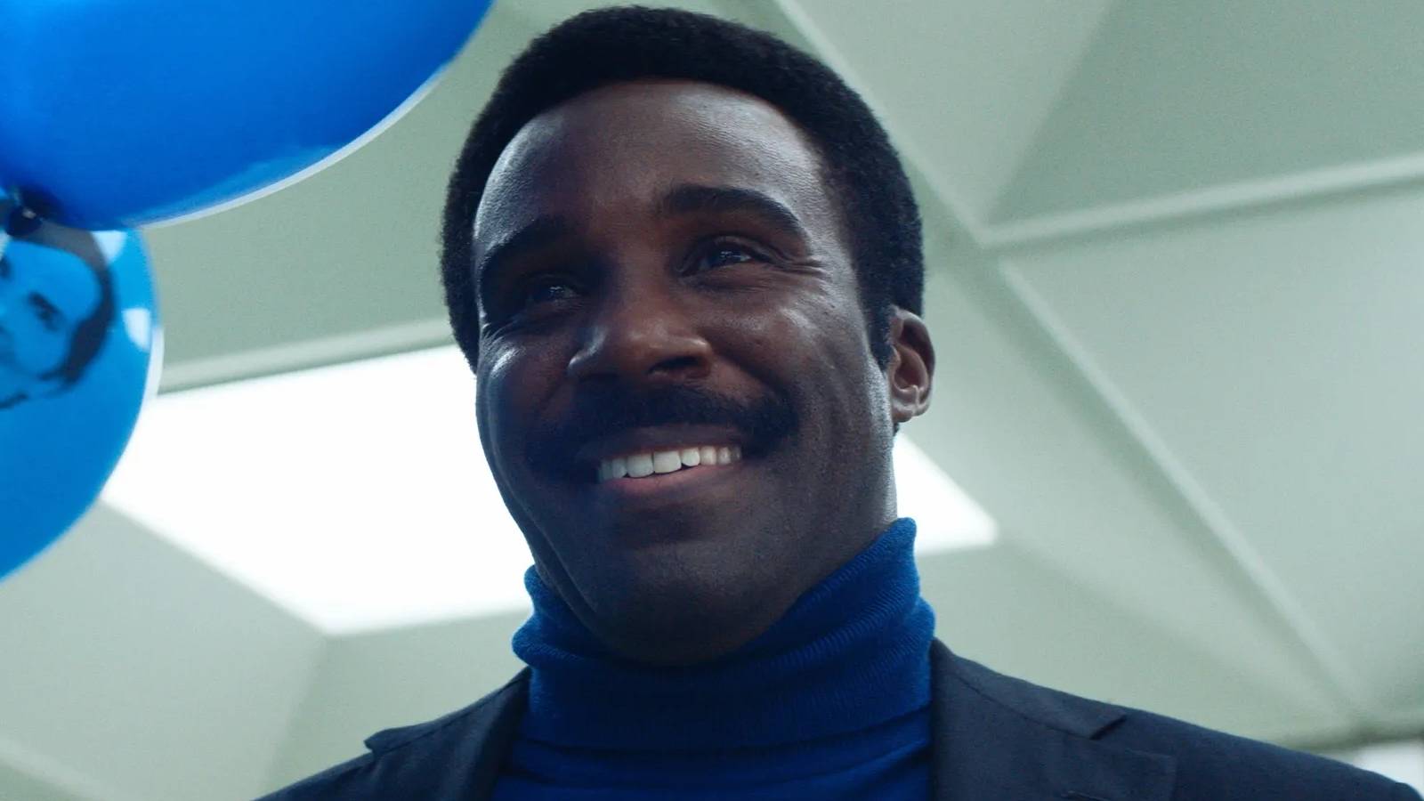 Mr. Milchick (Tramell Tillman) greets Mark with balloons in Severance season 2 episode 1