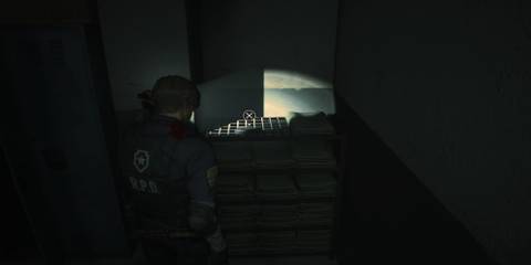 Leon Standing Over The Portable Safe Holding The First Spare Key 