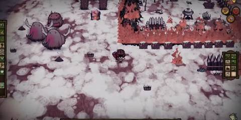 A still from the gameplay in DOn't Starve where the player is in the snowy biome