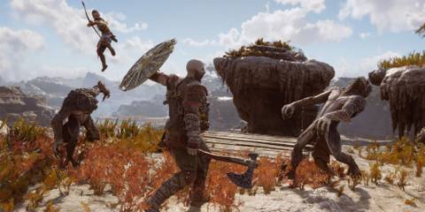 Kratos and Atreus fighting a bunch of enemies together.