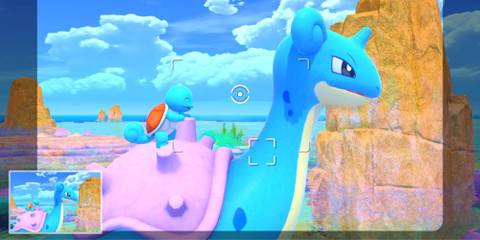The player takes a photo of Lapras and Squirtle by the sea.