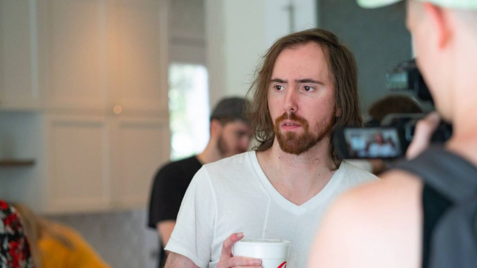 twitch streamer asmongold looking away with a camera trained at him
