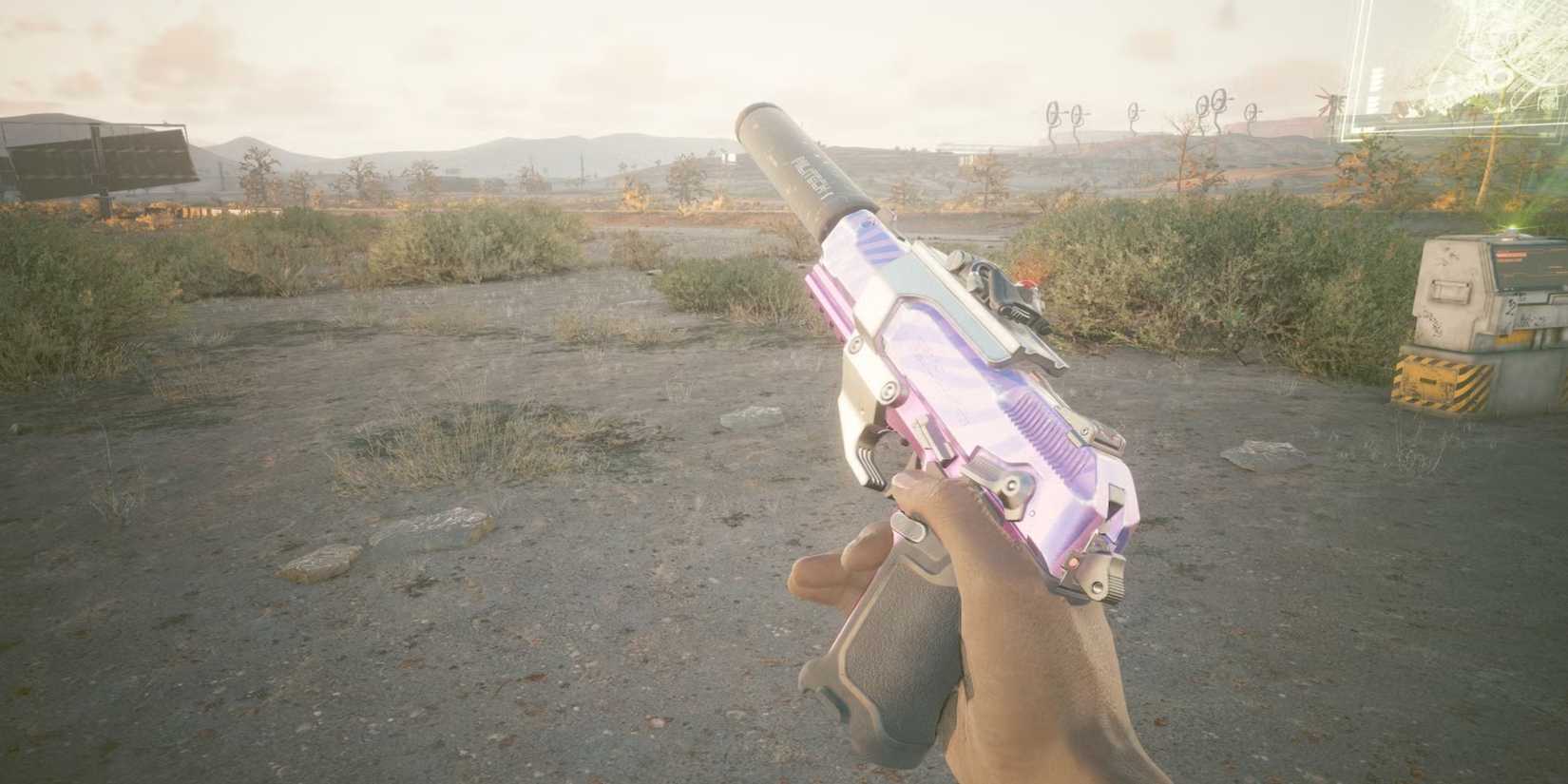 Cyberpunk 2077 player holding a pistol with a silencer attached to it 