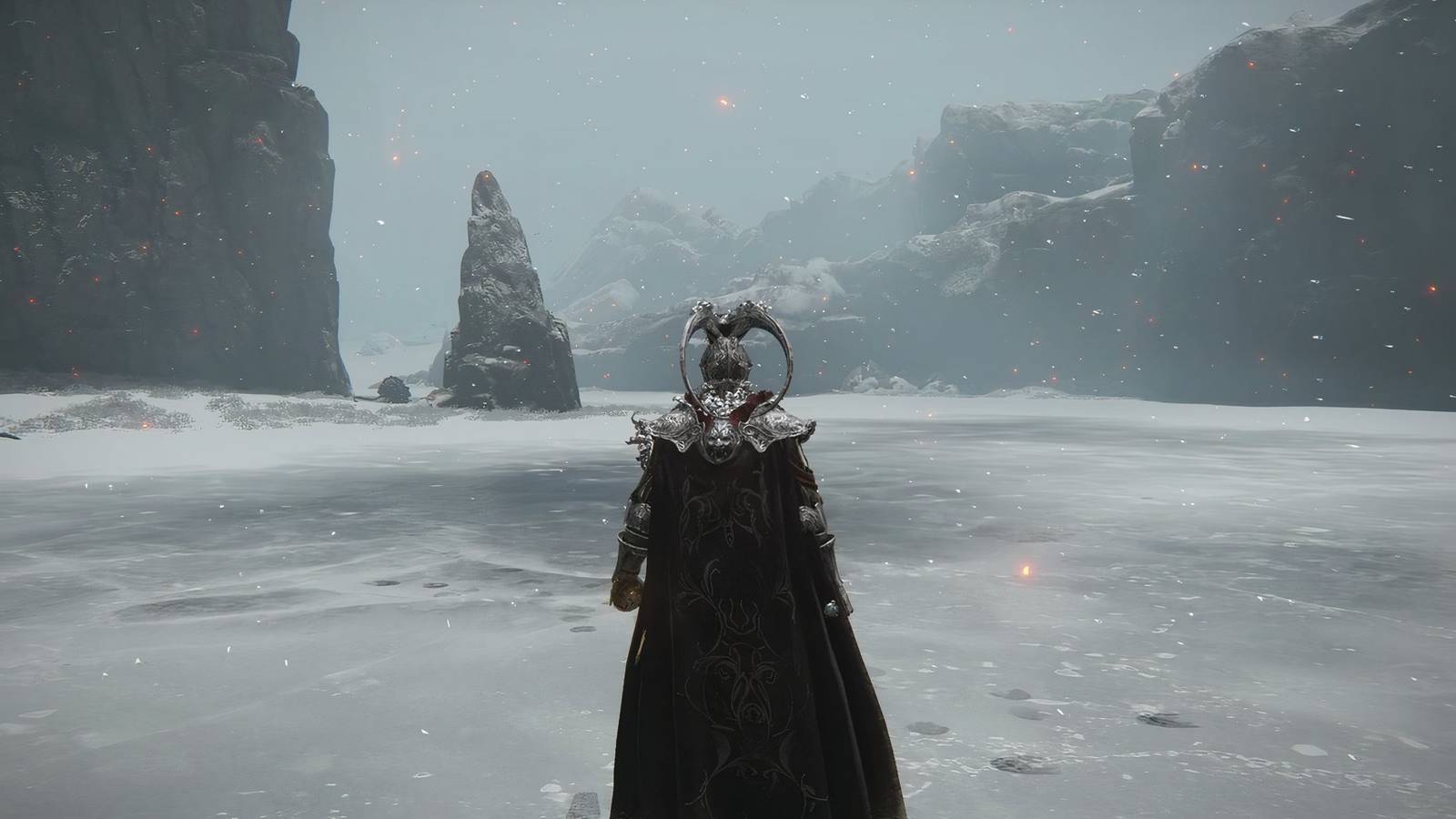 An Elden Ring player points out a mysterious hidden cave located beneath a chain bridge in the game's famous Mountaintops of the Giants region.