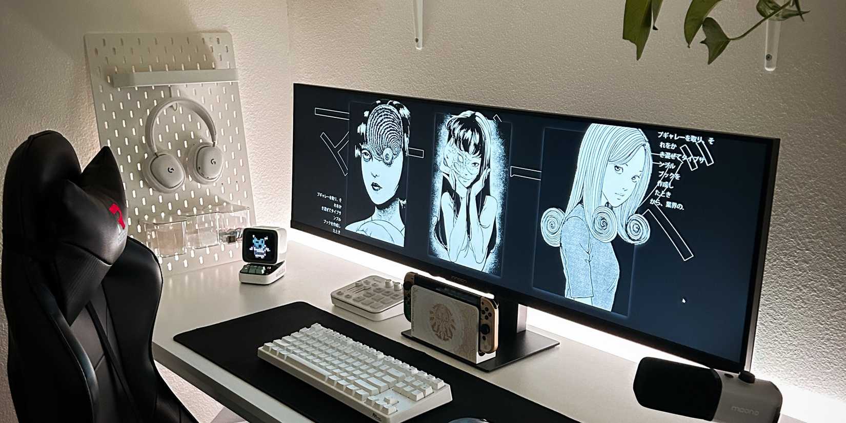 Ultrawide monitor gaming setup with a Switch and white keyboard