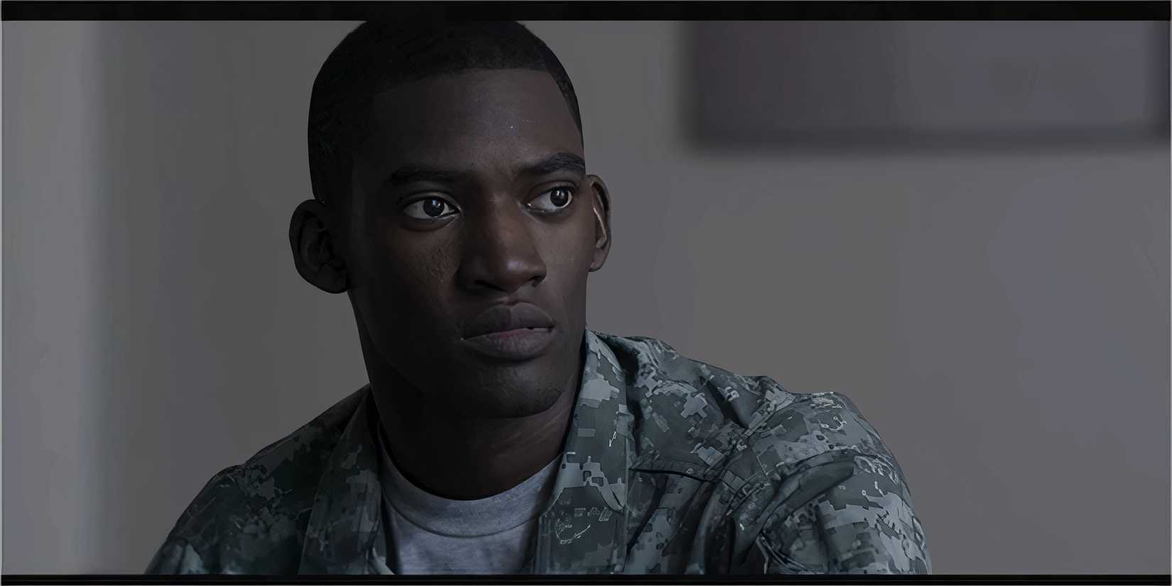 A soldier in a military uniform looking serious and concerned.