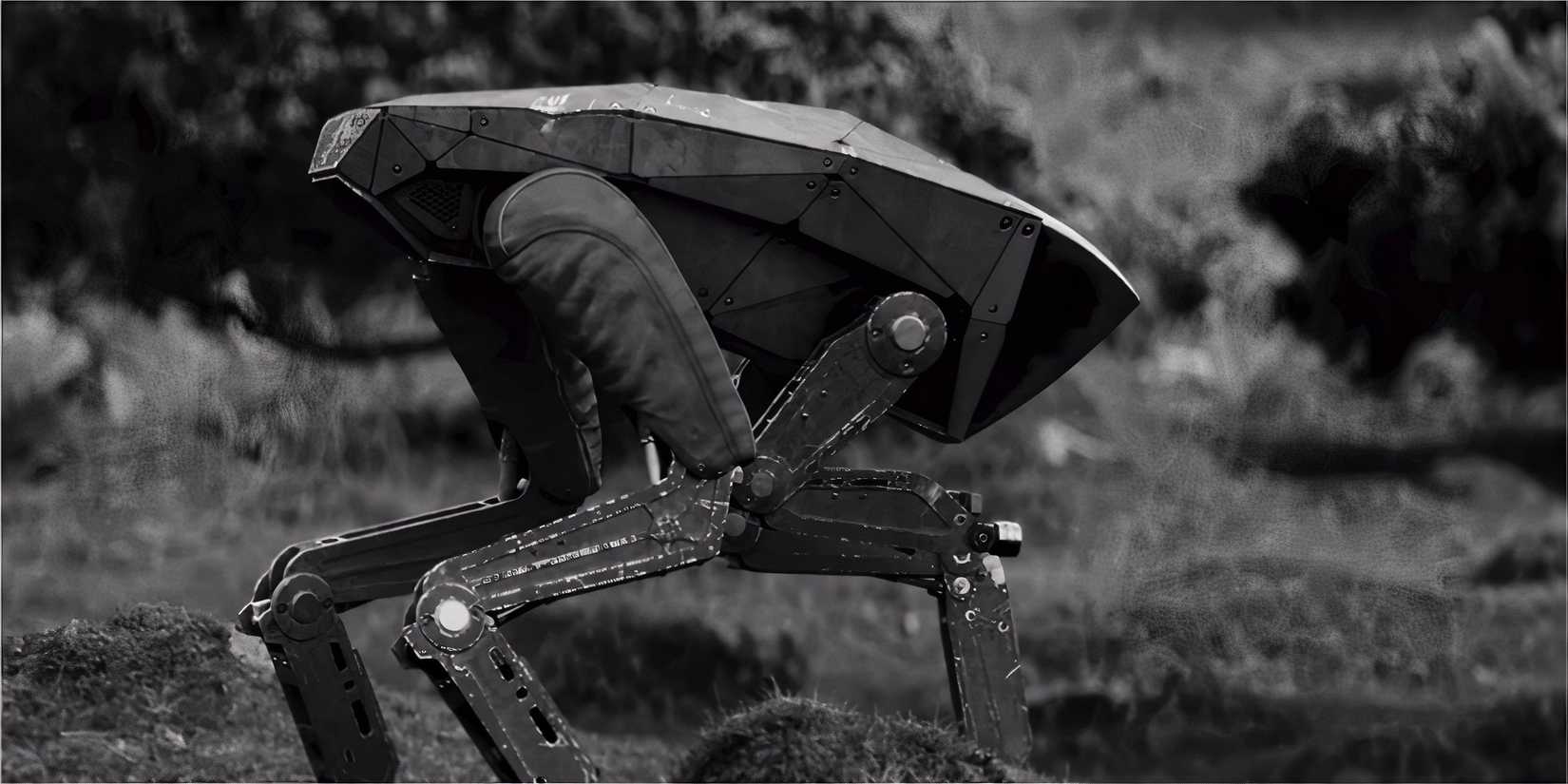 A robotic, four-legged machine standing alert in a black-and-white landscape.