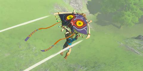 Link flying with the Majora's Mask paraglider in The Legend Of Zelda: Tears Of The Kingdom