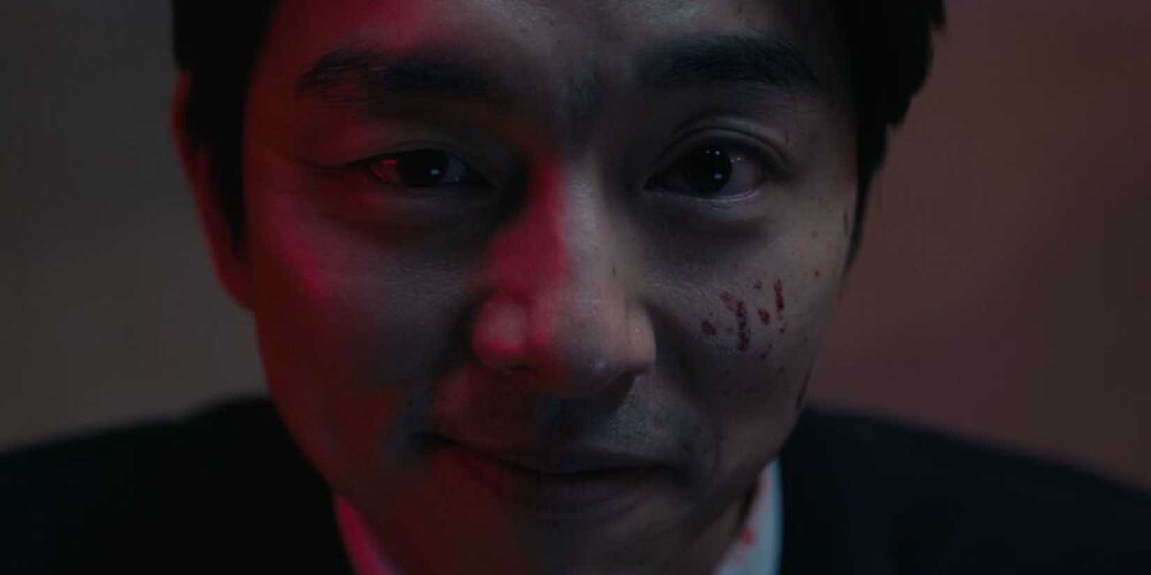 The Recruiter looks at Gi-Hun with a mix of emotions.