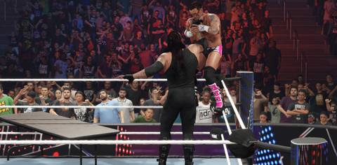WWE 2K25 Undertaker grabs Punk for the choke slam through the table