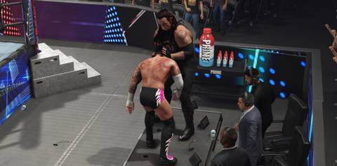 WWE 2K25 Undertaker prepares the finisher on the announce table