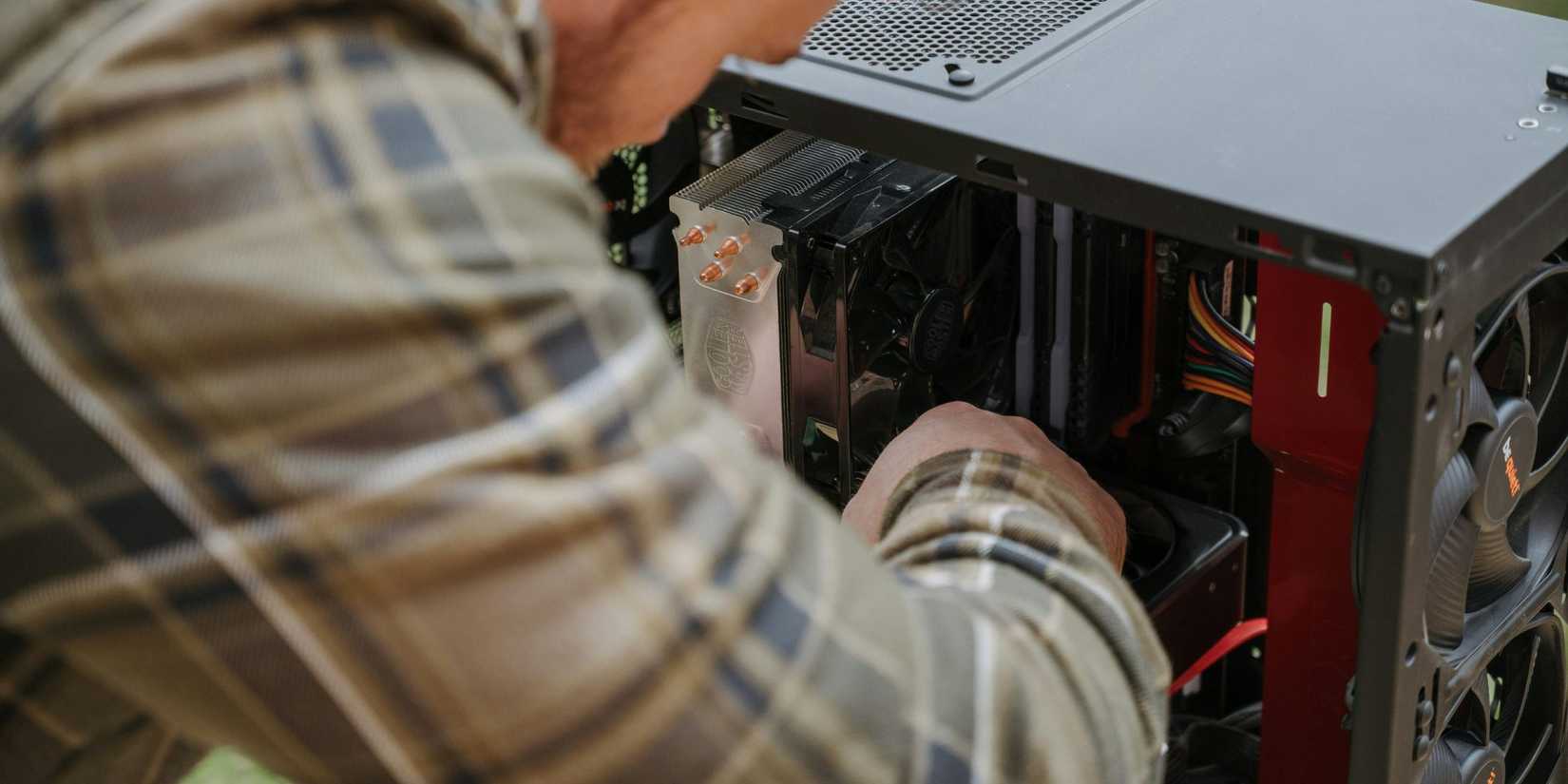 Image of a man custom building a PC.