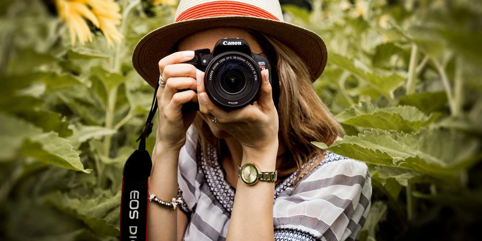 Image of a woman using a camera outdoors to represent durability.
