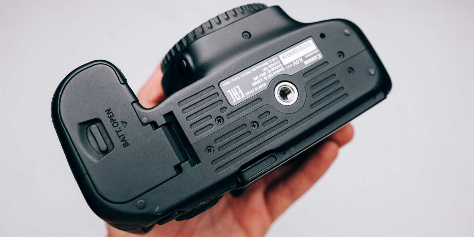 Image of a camera flipped over, showing the batter opening panel.
