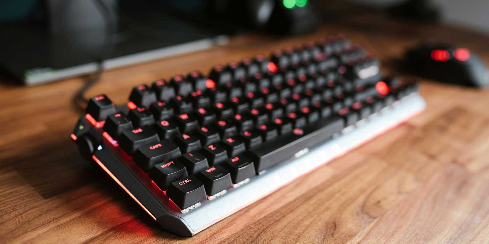 Lifestyle photo of a keyboard on a wooden desk.