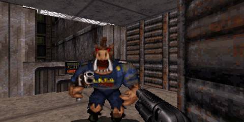 A Key Frame Showing A First-Person Perspective From Duke Nukem 3D With A Pig-Like Enemy Attacking The Player