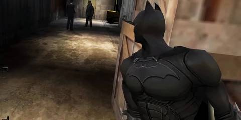 Batman peeking around a corner in Batman Begins