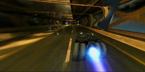 The Tumbler racing through Gotham City in Batman Begins