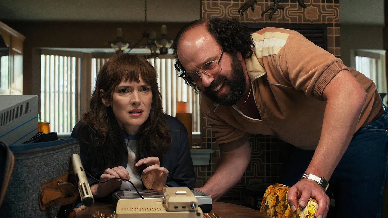 Joyce Byers and Murray trying to solve a mystery in Stranger Things