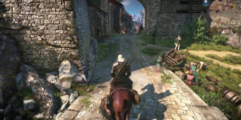 Geralt riding through a city in The Witcher 3: Wild Hunt