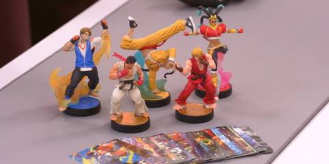 A promotional photo of Street Fighter Amiibos, showing figures for Ken, Ryu, Luke, Jamie, and Kimberly.