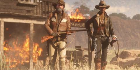 Two players walking away from a burning building in Red Dead Online