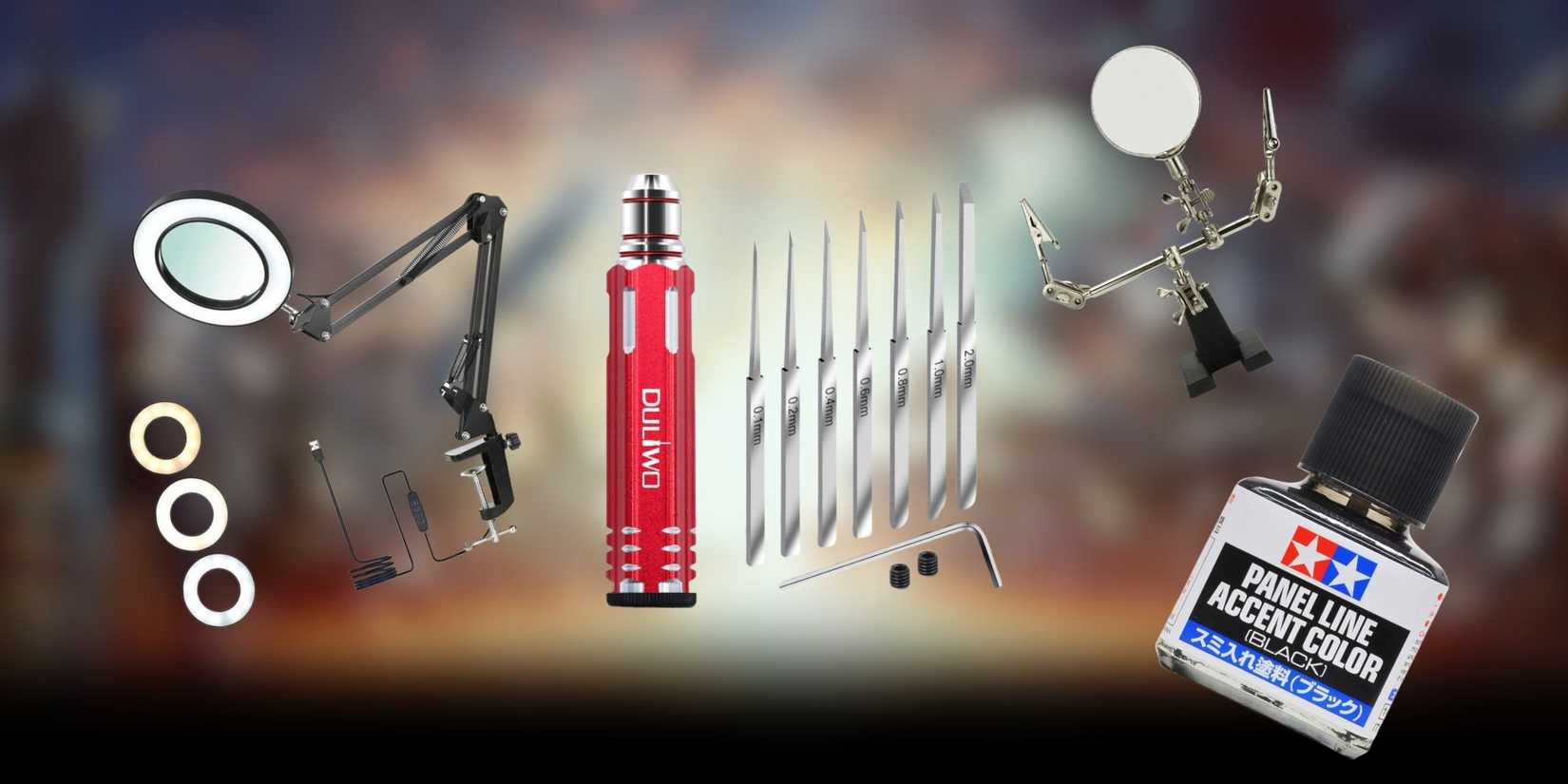 A war background with a magnifying model light, a pair of micro chiselling set, a panel line marker paint, and a hobby holder all spread out.