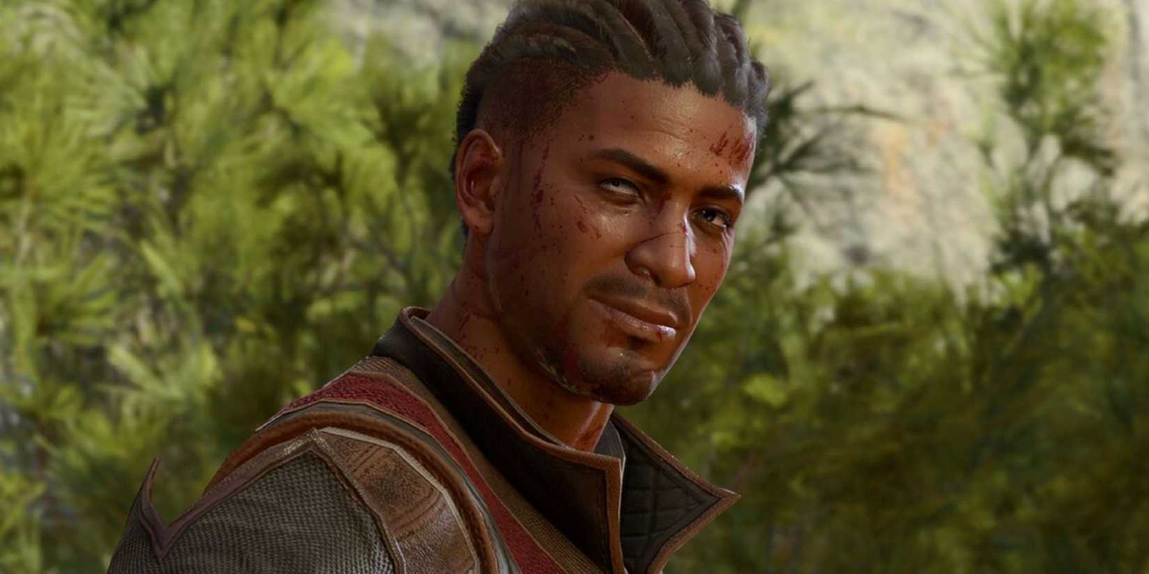 Wyll looking towards screen smiling with foliage in the background