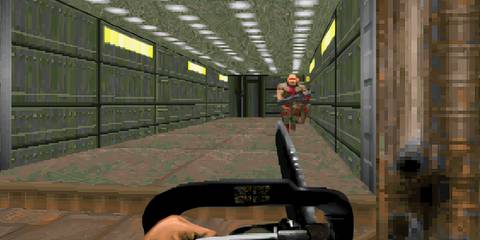 The Doom Marine with a chainsaw fighting a zombie in Doom 2: Hell On Earth