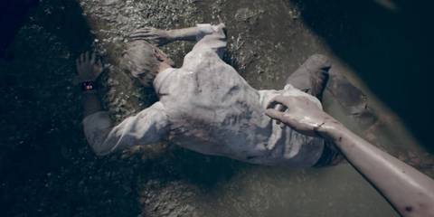 Ethan Winters lying on the floor in Resident Evil 7