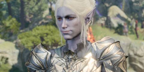 Minthara smiling with foliage and rocks in the background