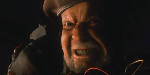 Mikhail plling the trigger with a serious face