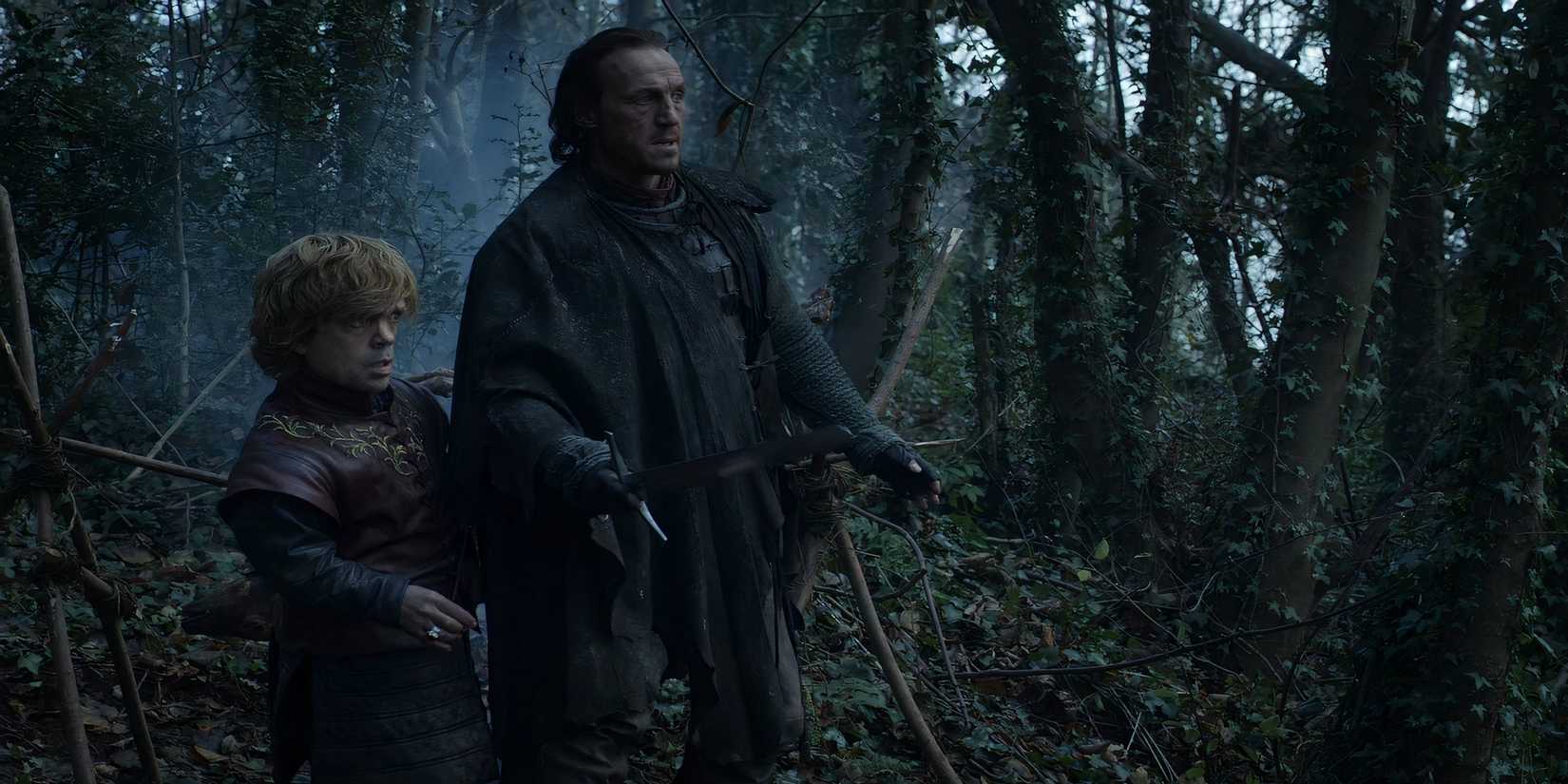 Tyrion Lannister and Bronn on guard in a forest in Game of Thrones