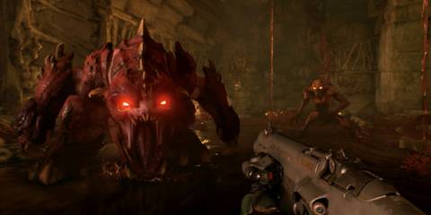 A massive demon with glowing red eyes charges toward the player in a dark, hellish corridor in Doom (2016) on Switch