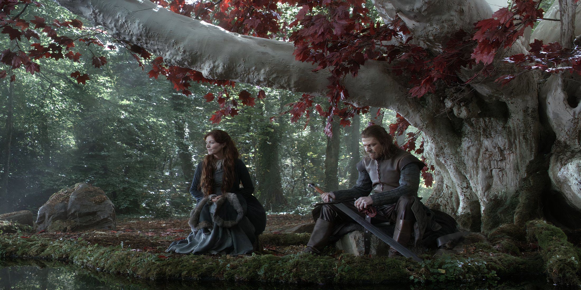Catelyn sitting next to Ned Stark who is sharpening his sword in the Godswood in Game of Thrones
