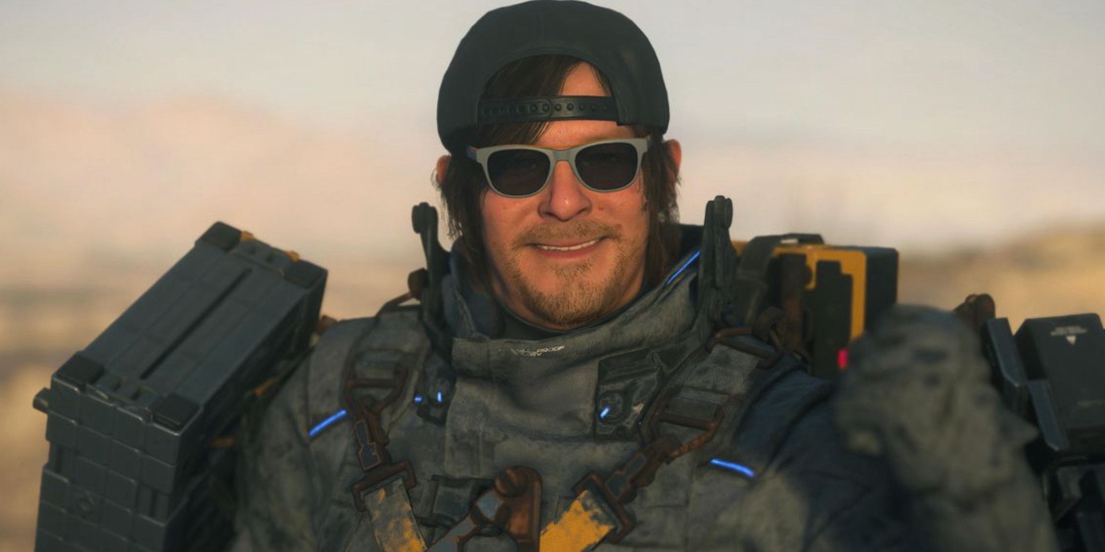 death-stranding-2-sam-bacwards-hat-sunglasses-smiling