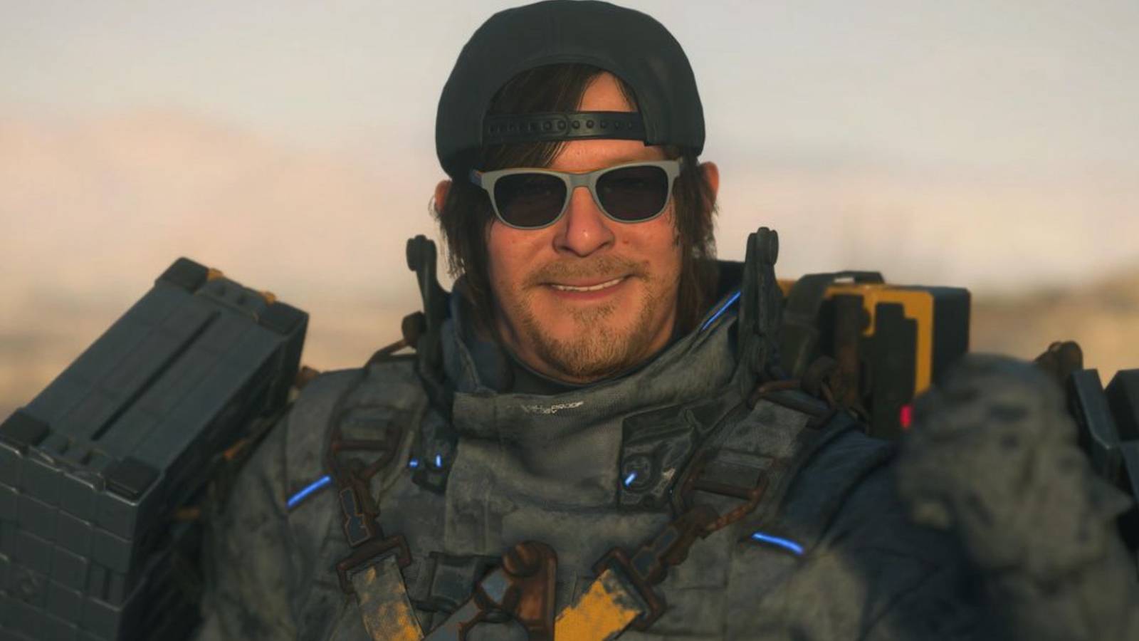death-stranding-2-sam-bacwards-hat-sunglasses-smiling