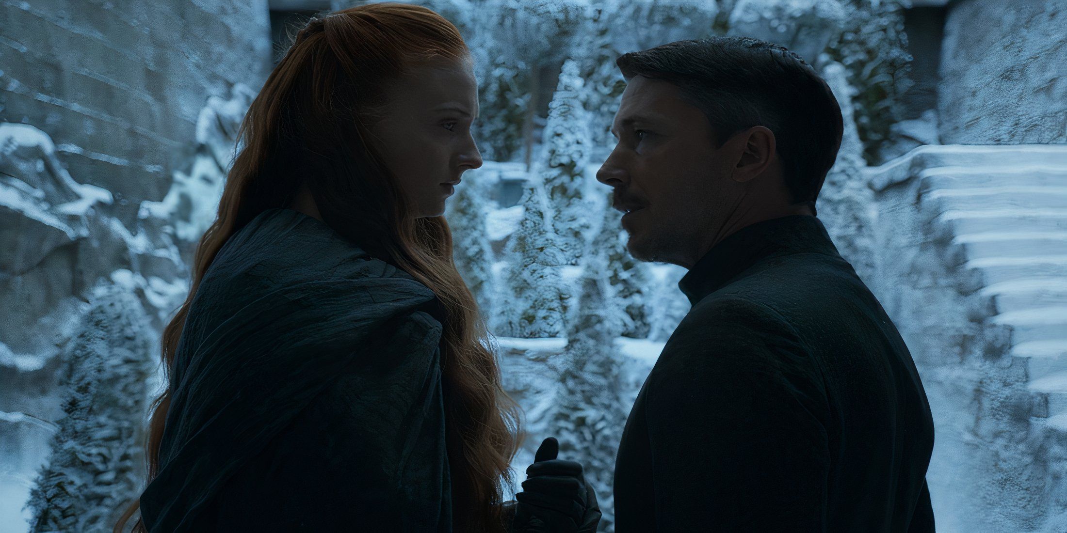 Sansa Stark and Littlefinger close together with a snowy background in Game of Thrones
