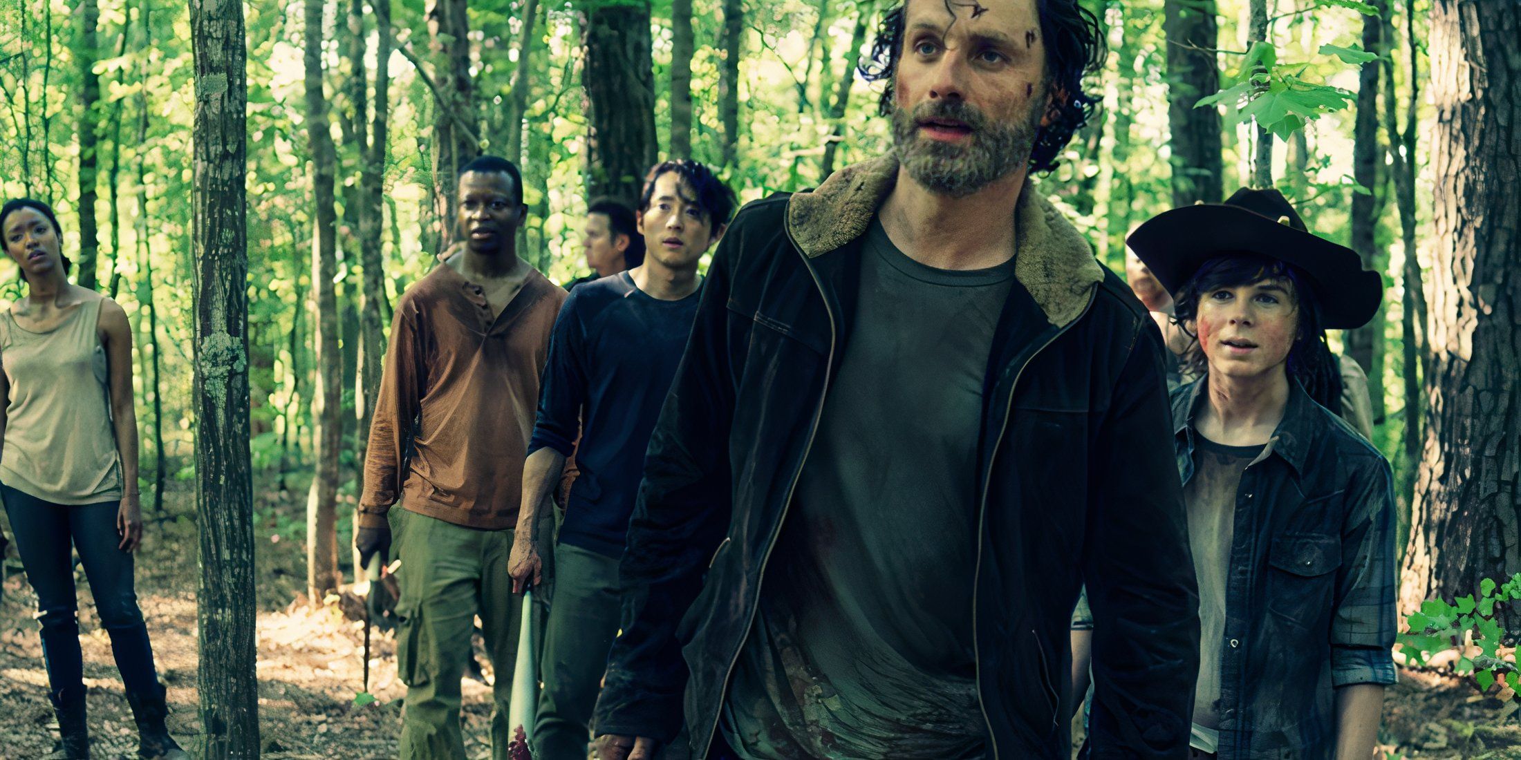 Rick and the gang walking through a forest