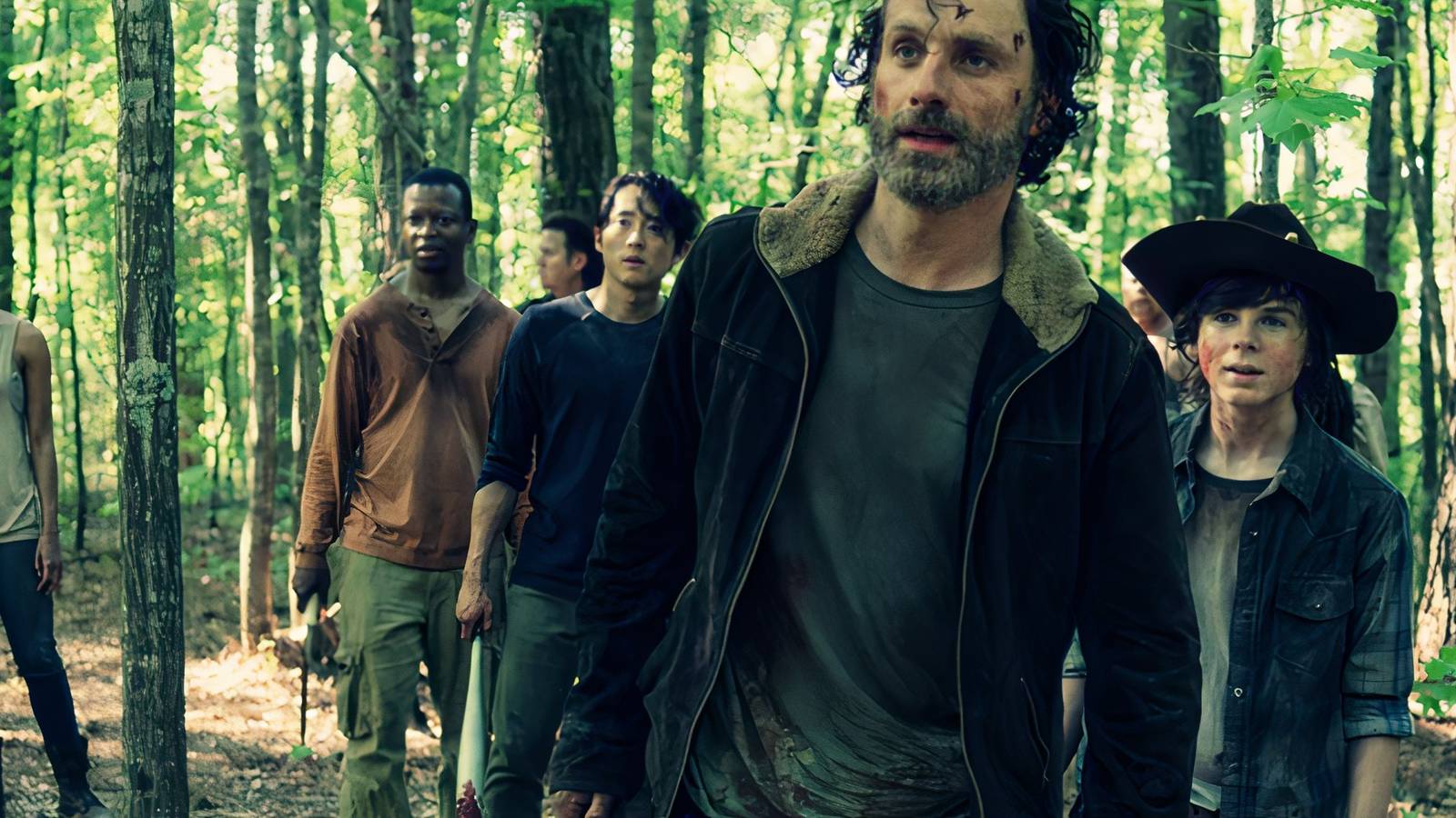 Rick and the gang walking through a forest